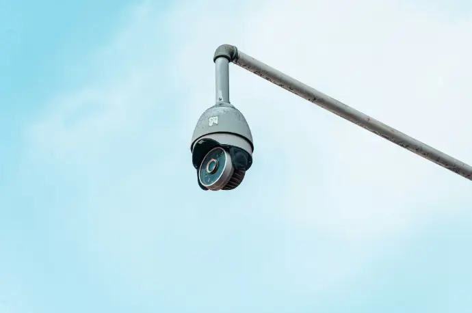 a camera attached to a pole with a sky background